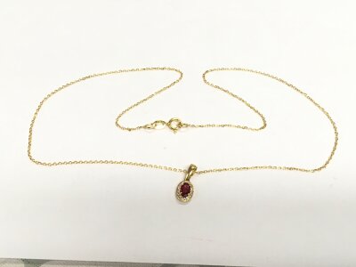 An 18ct gold oval ruby and RBC diamond cluster pendant on an 18ct gold chain. Ruby approx 0.31ct, diamonds approx 0.07ct, approx 1.8g.
