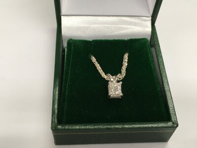 A 14ct white gold solitaire pendant set with a princess cut diamond on a Prince of Wales style silver chain. Diamond approx 0.50ct, approx 4g.