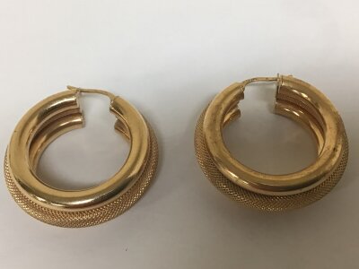 A Pair of  9carat gold hoop earrings with three hoops the centre with a close pattern.