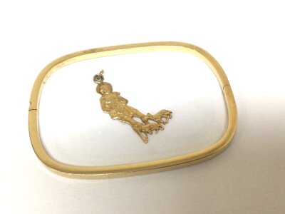 A 14carat (585) gold bangle of curved edge rectangle shape and a small gold charm unmarked tested 14carat approximately weight 9.8g