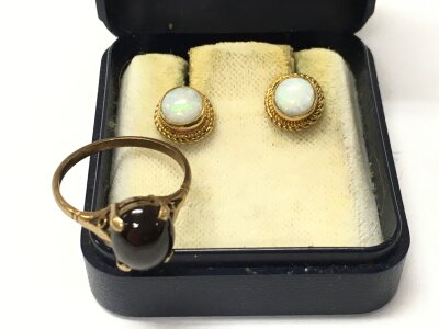 A 9 carat gold ring and a 9ct gold pair of opal earrings. 3.9g