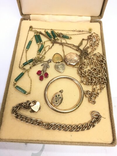 A collection of gold plated and silver gilt jewellery in a fitted case.