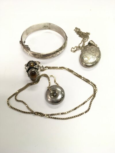 A silver locket, bracelet, ring and a Georg Jensen design pendant.