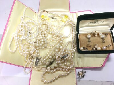 A collection of pearls including cultured pearls, Mikimoto earrings, a small brooch of a winged insect etc.