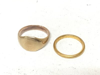 A 22carat gold wedding band weight 3g and one other unmarked gold ring weight 5.5g. (2)