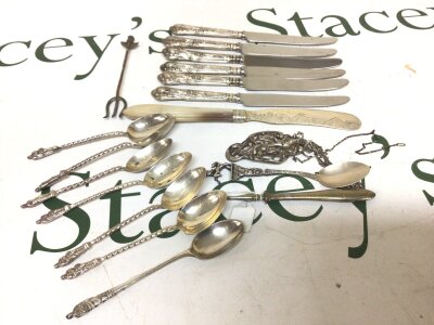 A Collection of silver apostle type tea spoons a large white metal pendent silver handled knifes and other oddments.