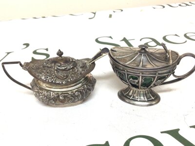 Two elaborate Silver mustard pots with glass liners (green liner damaged)