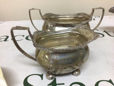 A Silver sugar bowl and cream jug with a patterned edge Birmingham hallmarks weight 285g