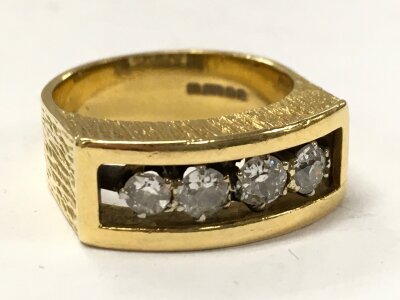 An 18ct gold ring with four diamond stones, size N ,8.4g