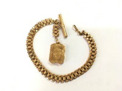 An 18ct gold watch chain and fob with attached double locket, approx total weight 64.8g.