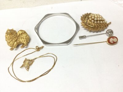 Six pieces of Trifari , a bangle, scarf pins, brooches, necklace
