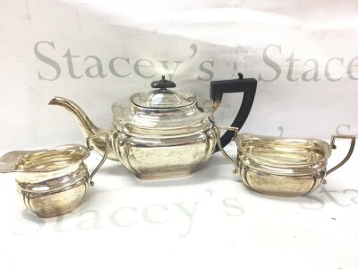 A silver hallmarked Viners 20th century three piece Silver tea and a pair of tongs. 10 to 14.5Cm tall. Total weight 1.1kg