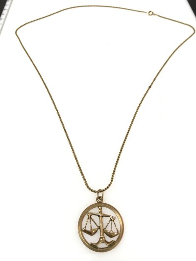 A 9ct gold necklace and 9ct gold Libra starsign pendant. Chain 30cm long. 10.9g