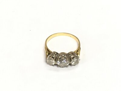 A gold ring three stone diamond ring, marks indistinct, approx 4.2g and approx size N.