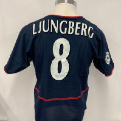 Arsenal 2002 - 2003 Match Worn Blue Football Shirt: Short sleeve blue away kit with Champions League badging to sleeve. Ljungberg number 8 to rear. Few stains to 02 sponsor and number. Signed COA stating I wore this shirt v Eindhoven on September 25th 2002. C/W press photo of him wearing the shirt and match report.