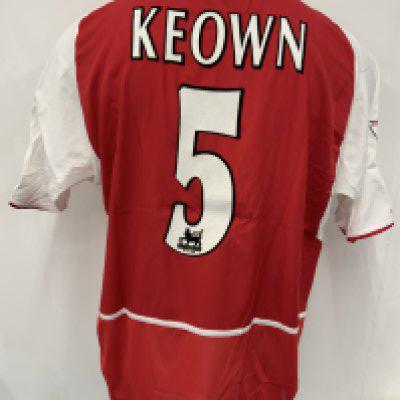 Arsenal 2002 - 2003 Match Worn Home Football Shirt: Short sleeve red home kit with Premier League badging to sleeve which states 2001 - 2002 Champions. Keown number 5 to rear. 02 sponsor. Signed COA stating I wore this shirt v Manchester City on September 10th 2002. C/W press photo of him wearing the shirt, programme and match report.