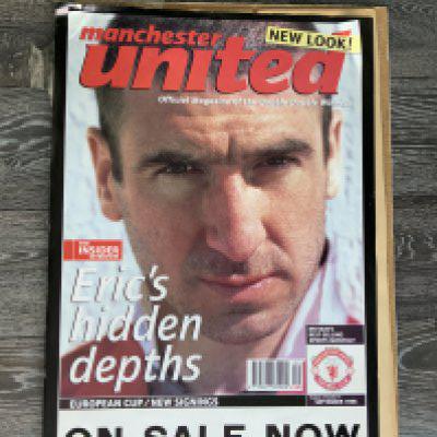 Eric Cantona Manchester United Magazine Advertising Poster: Promoting the new look official magazine of the double double winners for September 1996. Measuring approximately 18 x 27 inches picturing Eric.