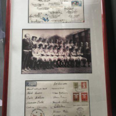 1977 Manchester United v Benfica Fully Signed Display: Alex Stepney testimonial featuring a team picture in the middle of Manchester United. Either side is a large first day cover. The top one is signed by 16 Manchester United players and the bottom one in the display is signed by 16 of the Benfica squad. Nicely framed and glazed.