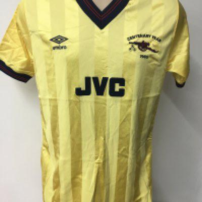 Kenny Sansom Arsenal 85/86 Match Worn Away Football Shirt: Umbro yellow JVC sponsored short sleeve shirt with felt number 3 to rear. Excellent condition with Umbro 80s label stating medium. Centenary Year 1985 either side of cannon.