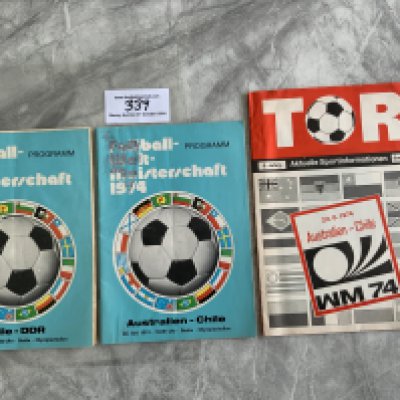 1974 World Cup Chile Football Programmes: Official programmes v East Germany tear at staples and Australia centre team page missing and a TOR Aktuelle version of the Australia match which is excellent. (3)
