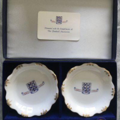 1963 FA Centenary Football Memorabilia: Stunning gifts and keepsakes given to Watford Director and all distinguished guests. Invitation to the 100th anniversary of the Football Association dinner plus an embossed velvet feel tasseled list of guests. Gift set comprising of two soap dishes a pen and two badges all with centenary three lions logo. Lastly from the dinner table is a boxed cigarette, cigar and box of matches. Nice collection.