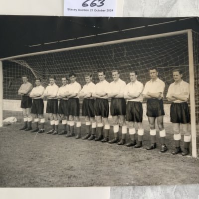 1955 England Team Group Press Photo: Eleven players pictured on the goal line at The Valley at a training session before a match v Denmark. Press stamp and annotations to rear.