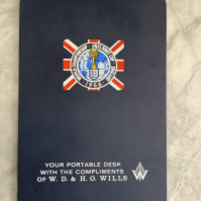 1966 World Cup Football Memorabilia: An official portable desk given to press which consists of a hard board with World Cup logo on it made by Wills. C/W original Watney Mann World Cup Pale Ale pennant featuring WC Willie holding a Watney barrel. Very good. (2)