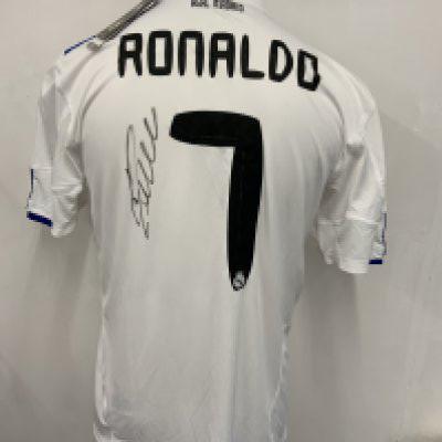 Signed Real Madrid Football Shirts: White unworn replica home shirts two with tags still attached. One has Ronaldo 7 to rear with his signature the others with a few unknown autographs. Came in to a valuation day without authenticity so signatures remain unverified. (3)