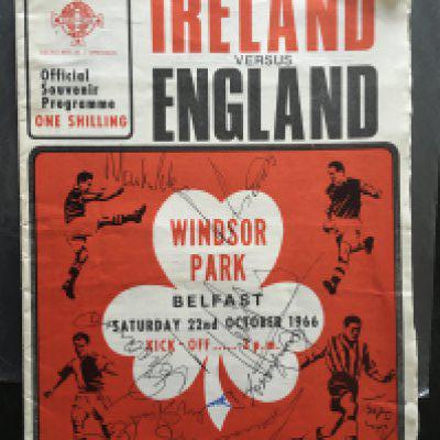 1966 England Signed Football Programme: Away programme at Windsor Park v Ireland signed to front in biro by newly crowned World Cup winners. Includes Moore Bonetti Peters Greaves and a few others who were journalists. Creasing.
