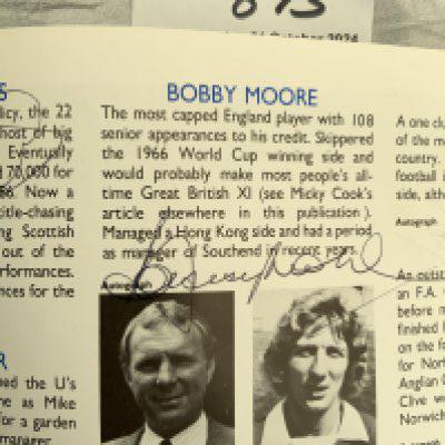 Bobby Moore Football Autograph: Signed inside a Micky Cook testimonial programme near his profile inside. Possible to cut out and re use with a good eye.