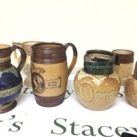 A collection of Doulton stoneware Victorian jugs Jubilee commemorative one with a silver collar. One stamped Thomas Wallis Holborn Circus. (6)