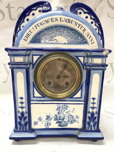 A Delft pottery mantle clock, featuring hand-painted blue and white porcelain with floral decoration . 31cm tall 22cm wide- NO RESERVE