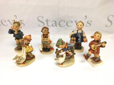 Six Goebel Hummel figures of children.