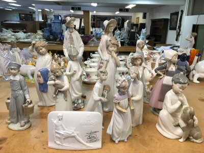 A collection of Lladro figures including gurl with lamb, various sizes.  Some A/F