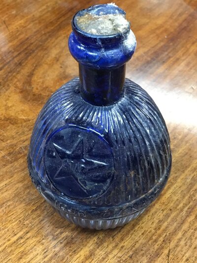 A blue glass fire extinguisher bomb. 17cm tall