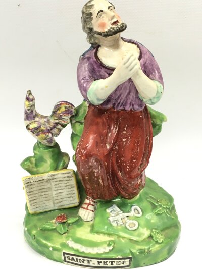 A 19th century Staffordshire pearl ware figure of Saint Peter. 21cm tall