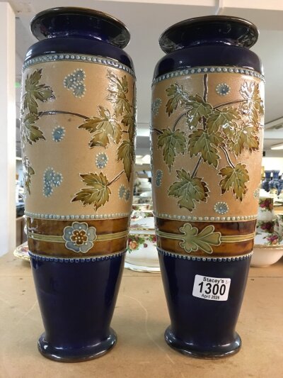 A pair Royal Doulton Lambeth Stoneware vases. 36cm in height. Decorated In flowers and foliage.