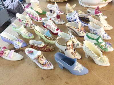 A collection of assorted ceramic shoe ornaments.