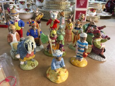 A collection of Royal Doulton Bunnykins figurines, together with two Royal Doulton Rupert figures- including Looking Like Robin Hood and Rupert's Silver Trumpet