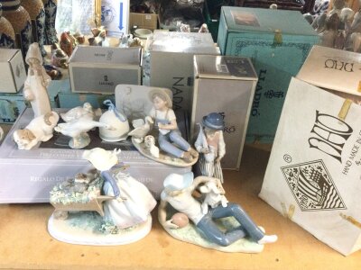A collection of boxed Lladro and Nao porcelain figures