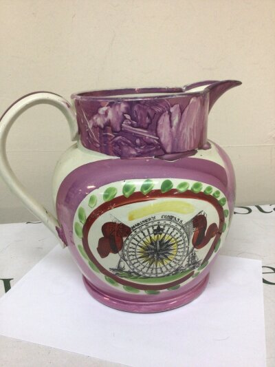 A Victorian Sunderland lustre Jug of large size 24cm high decorated with a West View of the iron Bridge built in 1795. With a printed Mariners Compass and rhyme. No obvious damage.