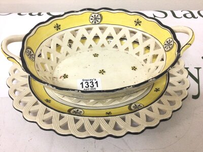 A 19th century or earlier Creamware basket and stand decorated with pale yellow and black pattern with open lattice work indistinctly marked to the base 28cm wide Hight 7-8cm approximately no obvious significant damage.