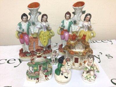 A Collection of 19th century Staffordshire figures cottages a small putti and other figures.
