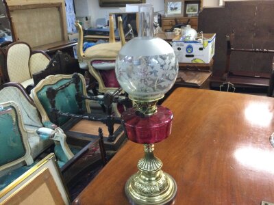 A late 19th century oil lamp with cranberry glass reservoir and brass base .66cm tall- NO RESERVE