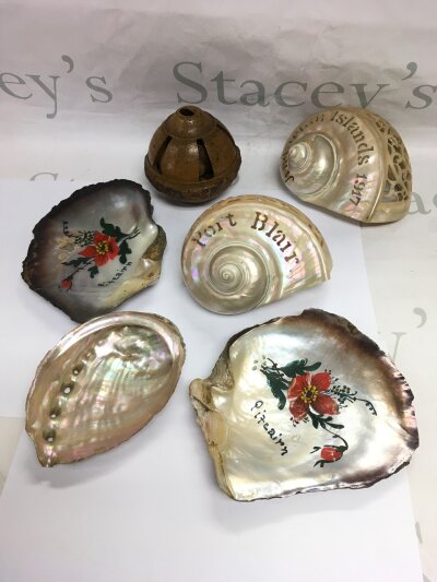 Five mother of pearl shells and a carved seed pod (6).