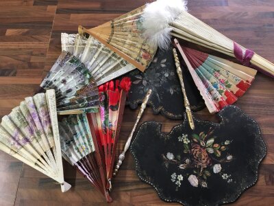 A collection of Fans including a hand painted vintage French Faucon fan, having mother of pearl and lace. Together with papier mache face screens and other assorted fans