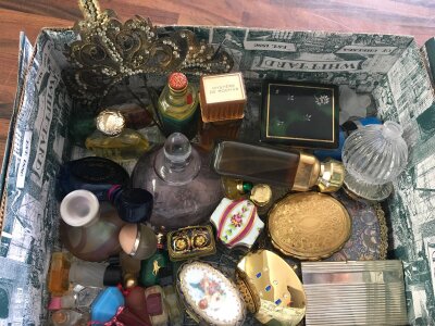 A box containing a collection of vintage perfume bottles, compacts and trinket boxes various