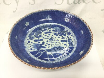 Chinese blue and white porcelain bowl with a dragon motif and scalloped edges. Approximately 24cm diameter.