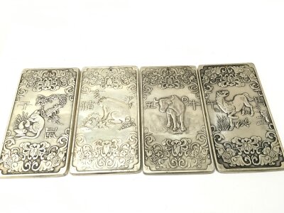 Four Chinese dragon ingots pendants silver style, approximately 9.5cm x 5cm . Total weight 540 grams