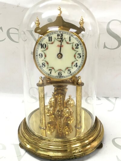 A Kundo Mantle clock under glass dome, made in west Germany.  23 cm tall.